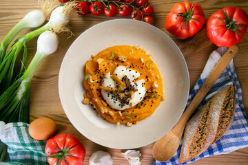 Sweet potato cream with poached egg and mushrooms. Top view table.