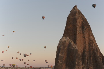 Beautiful view of hot air balloons floating in the air at sunrise with clear sky in Cappadocia, Turkey (Türkiye)