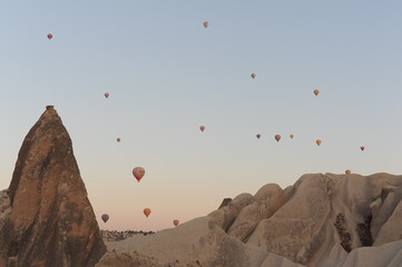 Beautiful view of hot air balloons floating in the air at sunrise with clear sky in Cappadocia, Turkey (Türkiye)