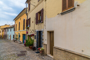 A view down the main street in the hilltop fortress village of Sant Andrea di Suasa, Italy in summertime