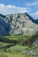 Mesmerizing panorama serpentine road running through hills and glades. beautiful day in nature among greenery and cloudy sky. Background for text or banner photo Hight quality