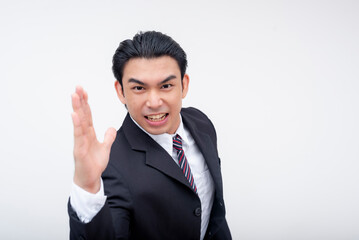 An abusive young asian businessman threatens to slap or karate chop someone with his hand. Isolated on a white background.