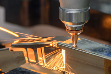 Close up scene the fiber laser cutting machine cut the square shape stainless steel tube with...