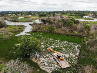Macrophyte cleaning from the lake in Brazil