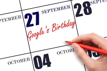 September 27. Hand writing text Google's Birthday on calendar date. Save the date. Holiday....