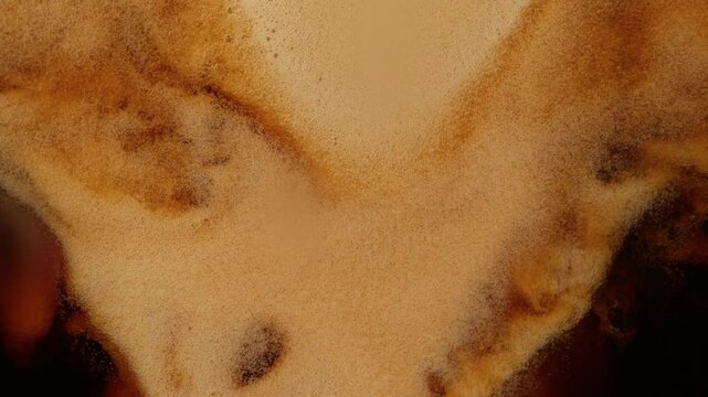 Super Slow Motion Detail Shot of Pouring Fresh Creamy Coffee at 1000fps.