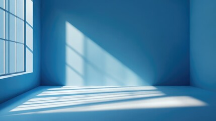 Obraz premium Minimalistic blue studio space with faint window shadows, perfect for a clean and contemporary product presentation.