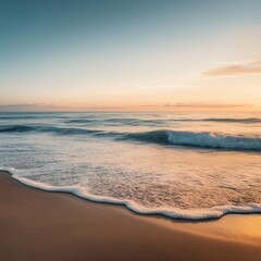 Peaceful ocean waves breaking on a sandy beach at sunset.