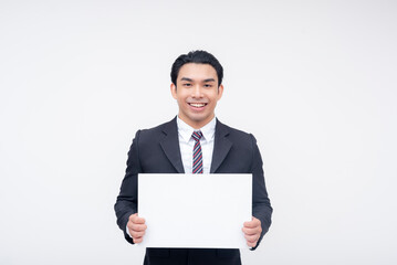 A young asian business executive smiling while holding a white blank signage. Isolated on a white background.