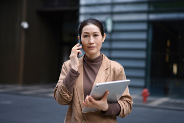 Professional Woman Engaged in Business Conversation on Street