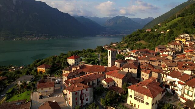 Cinematic Sunset Aerial Drone View of Claino con Osteno Medieval Village Lake Lugano Northern Italy Romantic Lakeside Architecture Nestled Among Alpine Mountains Tranquil Summer Evening 4K footage