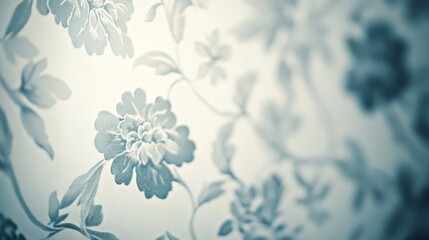 A soft-focus floral wallpaper design featuring delicate blue flowers and intricate vines against a light background.
