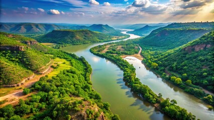 An Aerial View Of The Meandering Narmada River In India, With Lush Green Vegetation And Surrounding Hills