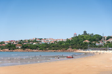 Serene Summer Day at a Scenic Beach with Coastal Town Views