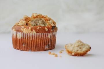 Homemade Muffin with Streusel Topping and Crumbs on White Grey Background