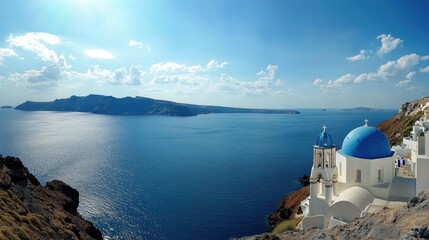 Fototapeta premium A panoramic view of the blue-domed Orthodox Church in Oia, Santorini, with the crystal-clear waters of the Aegean Sea and bright blue sky in the background