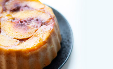 Close up soft focus gluten free peach cake isolated on white with copy space. Close up.