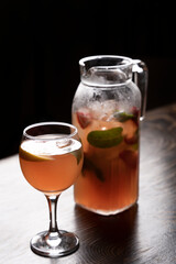 Cocktail in a glass with ice and mint on a wooden table