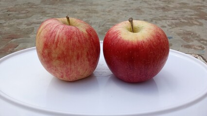 couple of fresh red apples on the basket