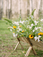 flowers in wooden flower box on grass