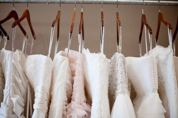 wedding dresses hanging on rack horizontal