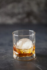 Glass of delicious Old Fashioned Cocktail on dark background