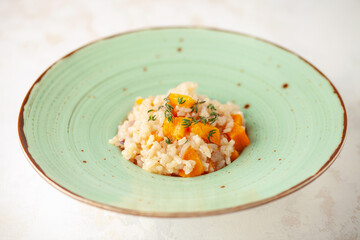 Pumpkin risotto with fresh thyme in plate. Italian Food