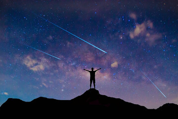meteorites fly in the night sky. Bright meteors glow in the atmosphere. Beautiful shooting stars.
