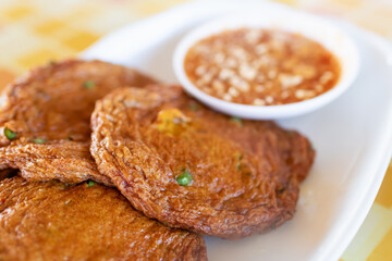 Fried crabs-paste balls in dish usually served with dipping plum sauce and sliced of fresh cucumber with chili.