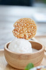 Delicious dessert featuring creamy ice cream topped with a crispy wafer.