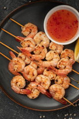 Portion of shrimp skewers with sweet and sour sauce