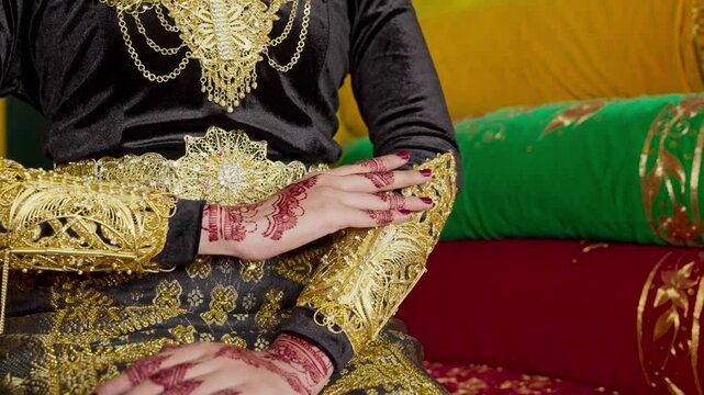 The bride's hands decorated with henna. There are many different names for henna tattoos around the world, such as mehndi, inai, hina, camphire, and hena
