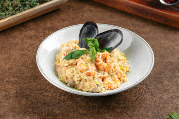 Portion of seafood risotto with mussel shells