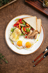 Portion of restaurant breakfast with fried eggs and sausages