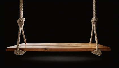 Wooden swing isolated on black background.
