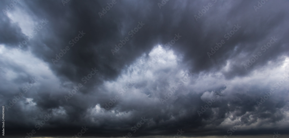 Poster The dark sky with heavy clouds converging and a violent storm before the rain.Bad or moody weather sky and environment. carbon dioxide emissions, greenhouse effect, global warming, climate change.