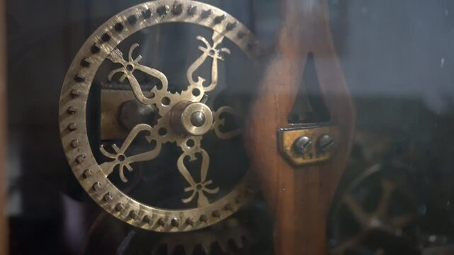Old pendulum mechanism in the town hall clock. Tower inside. Clockwork details