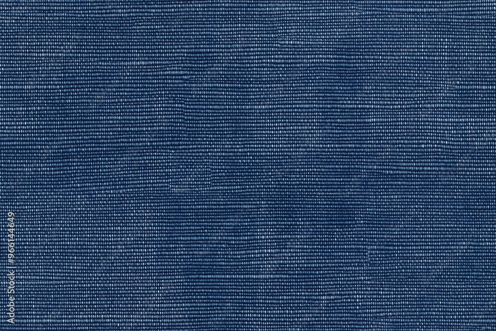 Poster textured blue cotton chambray fabric, showcasing a woven pattern with subtle variations in shade and