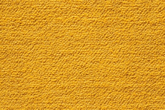 Textured cotton chenille yellow fabric, featuring a pattern of small, rounded bumps that create a tactile appearance. The vibrant yellow color adds warmth and brightness to the image.