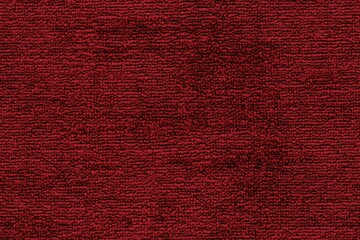 Fototapeta premium Textured red cotton chenille carpet, showcasing its rich color and soft fibers. The surface appears plush and inviting, perfect for interior decor.