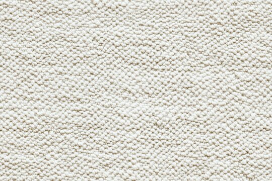 Textured white fabric cotton chenille surface, showcasing a soft and woven appearance. The fabric has a subtle pattern, ideal for backgrounds or textile design.
