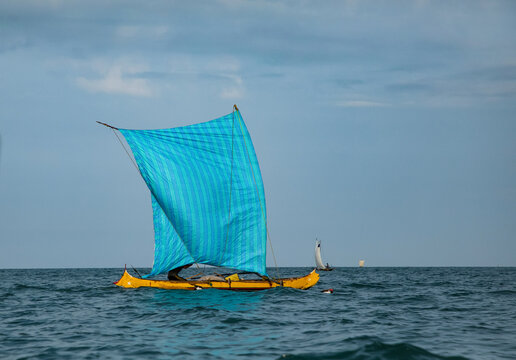 Malagasy fisherman on wooden old pirogue