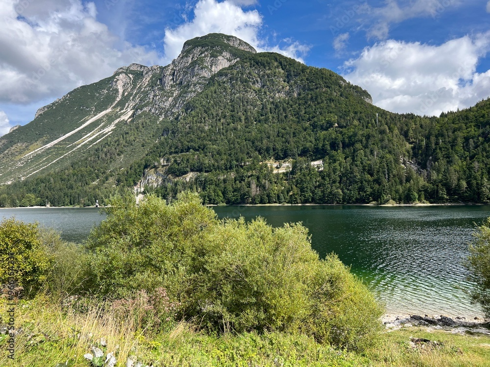 Wall mural early autumn over the alpine lake lago del predil or lago di raibl (cave del predil lake) - inizio a