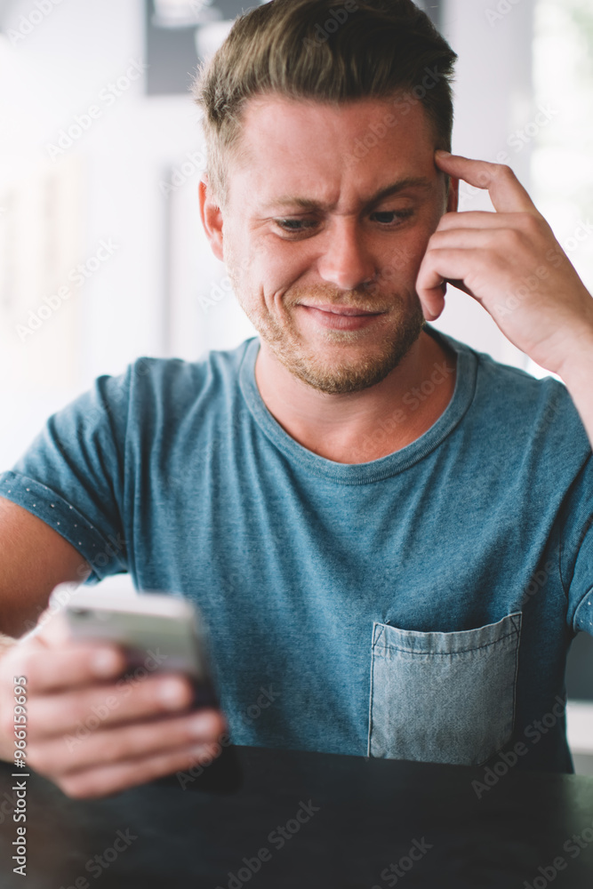 Poster caucasian hipster guy puzzled with fail banking operation on cellphone device reading information ab