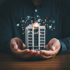 Hands Holding Smart Building with IoT and Technology Icons