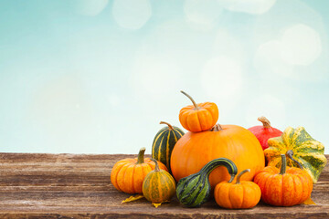 pile of raw orange pumpkins on wooden table border isolated on white background