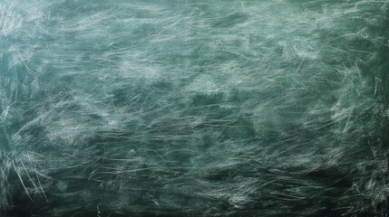 Fototapeta premium A close-up of a green chalkboard with a worn, textured surface. Perfect for adding a vintage, rustic feel to your design projects.