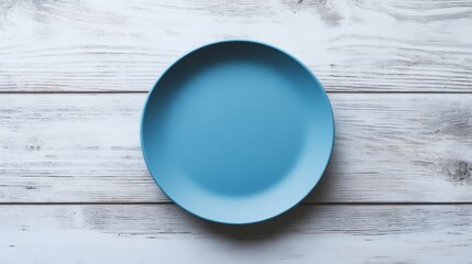 Blue ceramic plate on rustic wooden table, minimalist kitchenware design concept