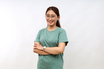 Portrait of young asian woman standing with folded hands over white background