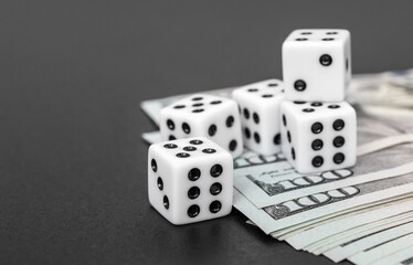 Dices with dollar bills on black.
